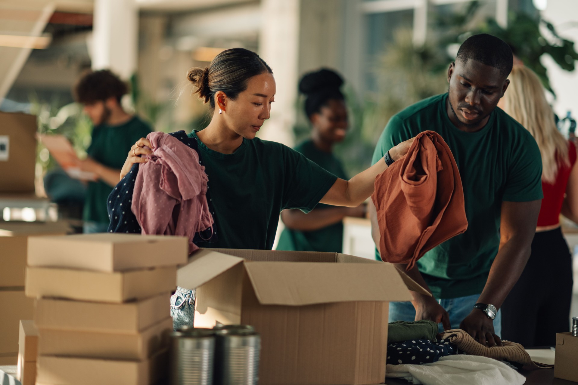 Volunteers sorting clothes and canned food for donation