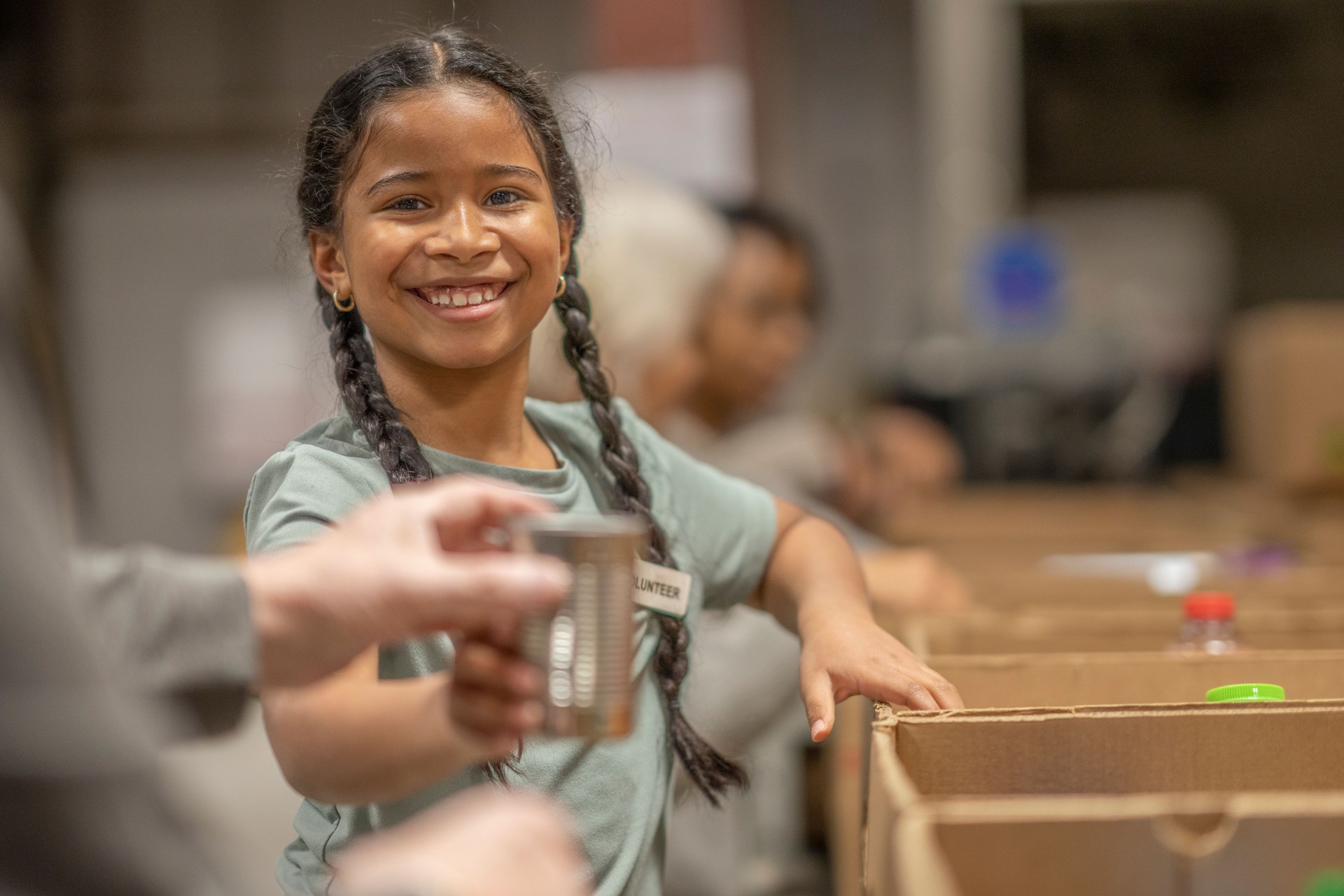 Young Girl Helping Pack at a Food Bank